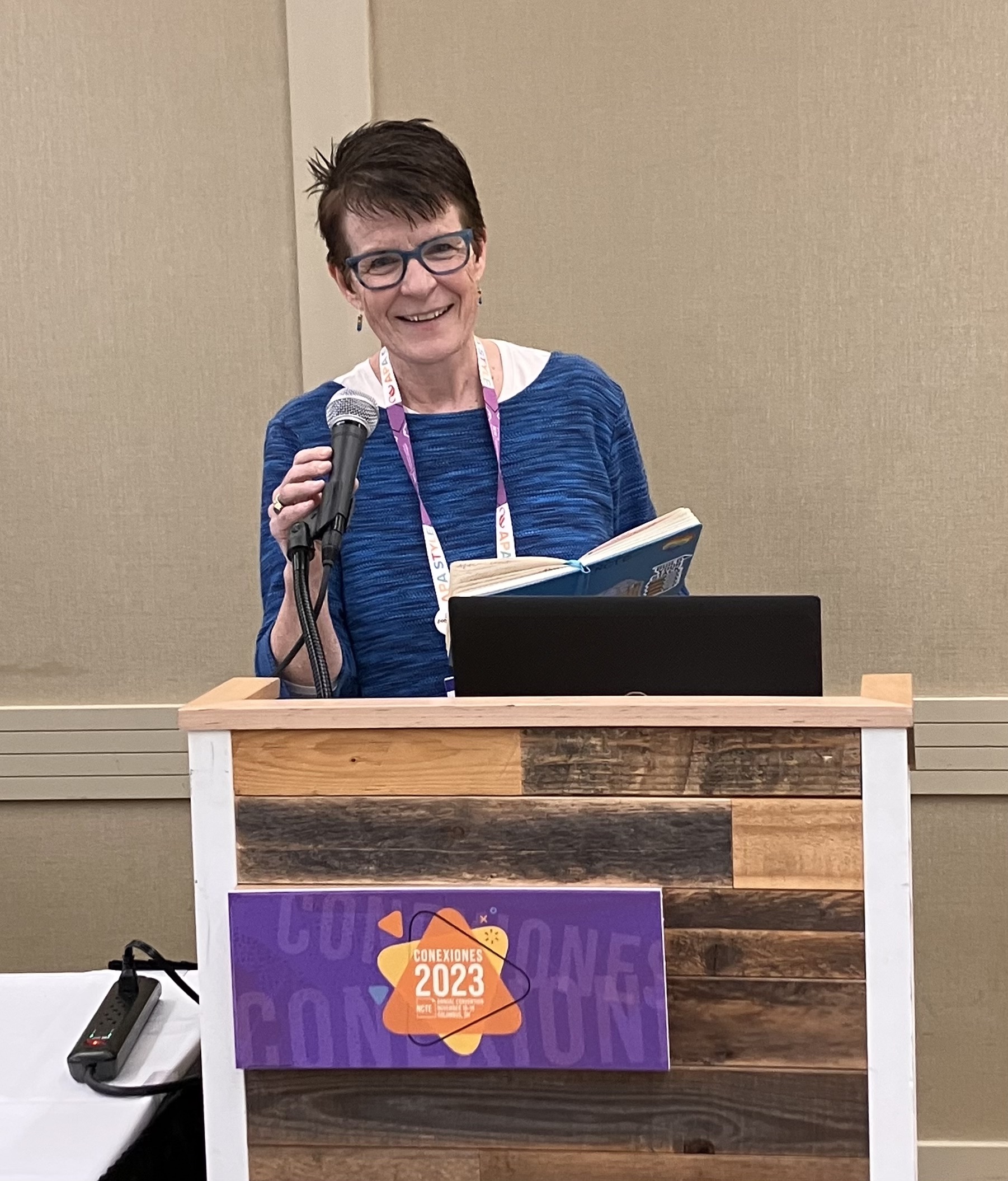 Cronin-NCTEpodium2023 Mary E. Cronin at a podium at the NCTE Convention