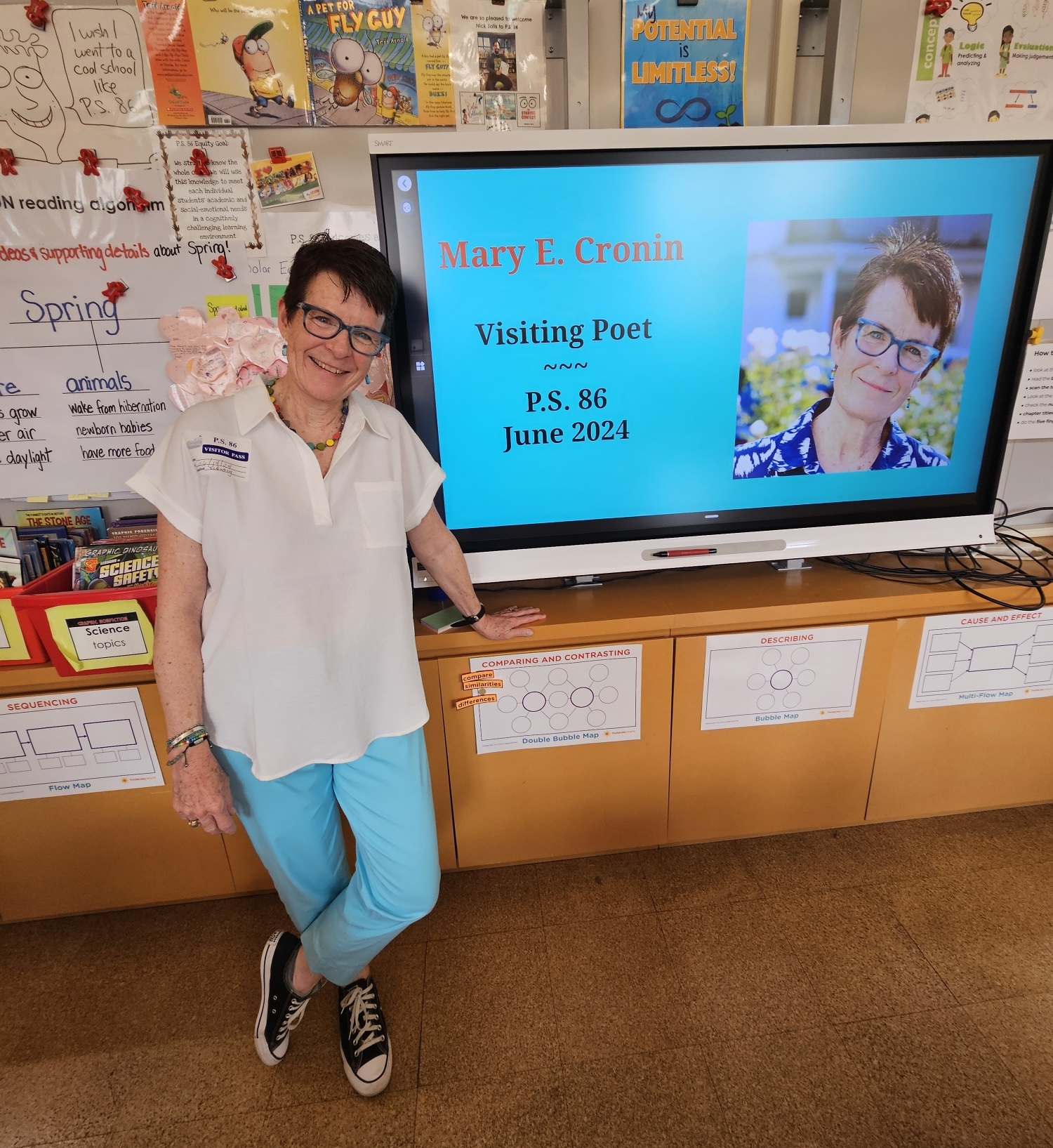 MEC-at-PS86-2024 Mary E. Cronin stands at an elementary school smartboard with her name and picture on it